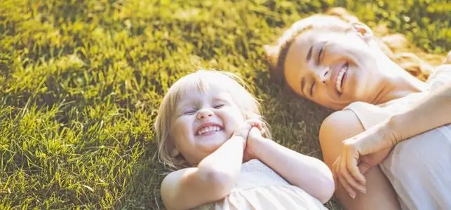 mom and girl laughing